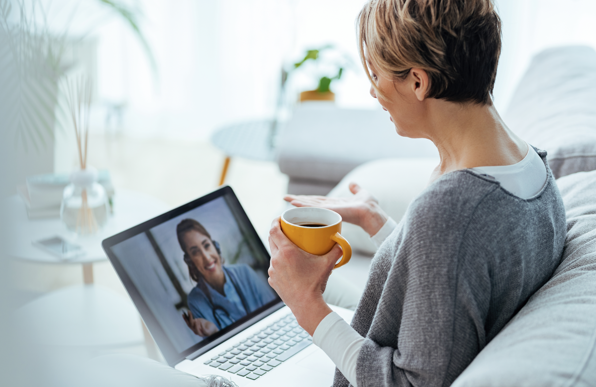 Woman having telehealth visit on her laptop